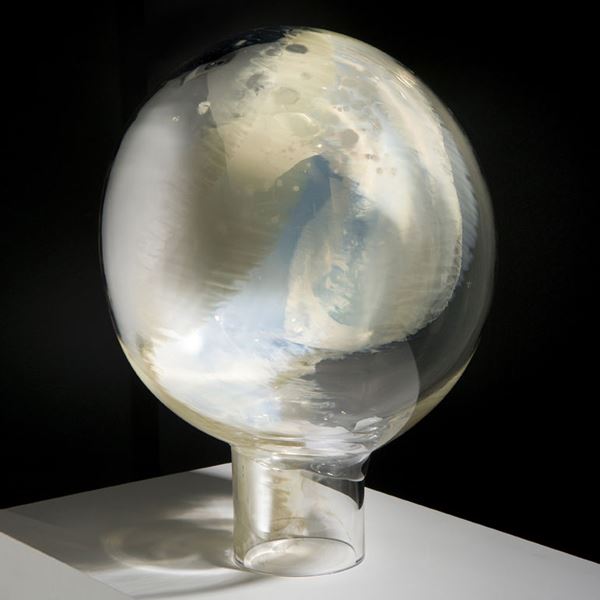 globe shaped minimalist glass sculpture resembling a mirror in white and pearl