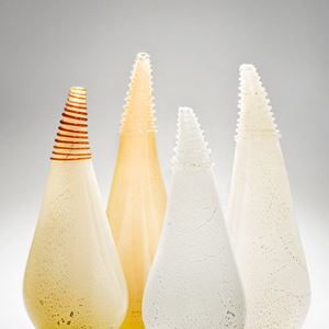 four art glass vessel sculptures in shades of white and gold