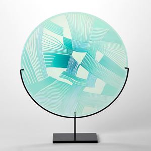 aqua and jade translucent round glass rondel with abstract patchwork landscape cutting on the surface handmade from glass and presented on a matt black steel stand