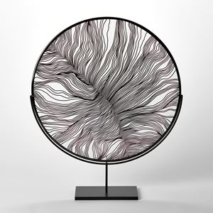 clear and black glass rondel with cut surface pattern resembling the details of a feather and a black rim hand made and presented on a matt black stand