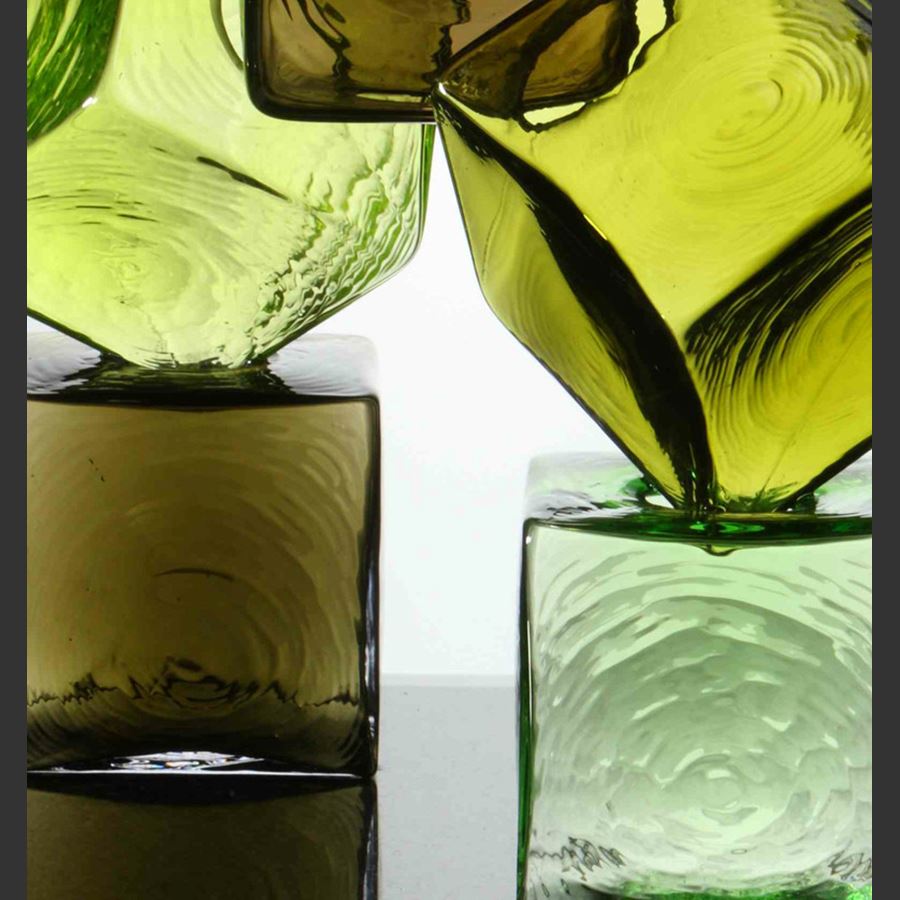 artwork of cubed glass pieces in green and brown colours on black rectangular base
