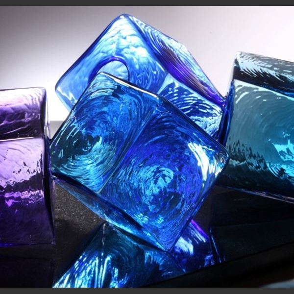 artwork of light and dark blue and purple glass cubes on black rectangular base