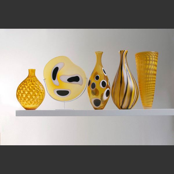 five handblown glass vases in shades of yellow with various patterns