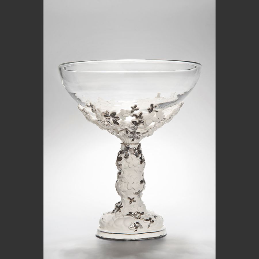 clear glass bowl sculpture with ornate porcelain base in white and grey