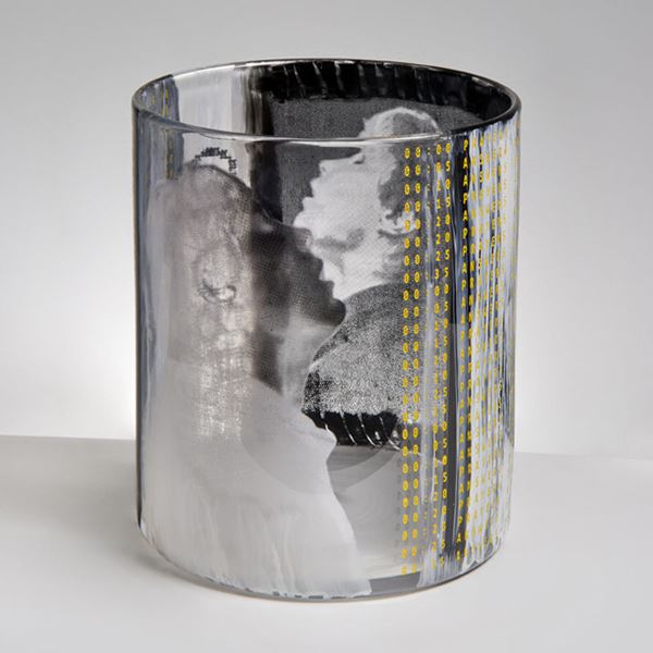 sculpted clear glass tumbler sculpture adorned with the face of a young boy