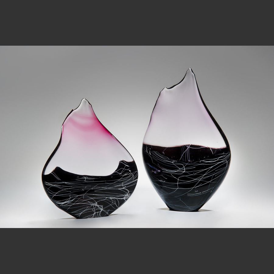 blown and sculpted glass ornament in abstract teardrop shape in black clear and pink 