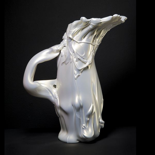 abstract shaped glass sculpture in pearly white of a pitcher