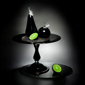 still life sculpted glass scene of cut fruit in black and lime colours