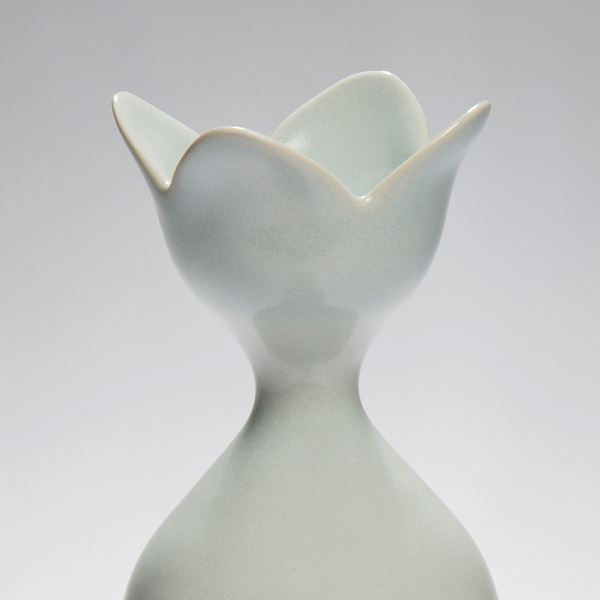 tall pale blue ceramic vase sculpture with flower shaped rim