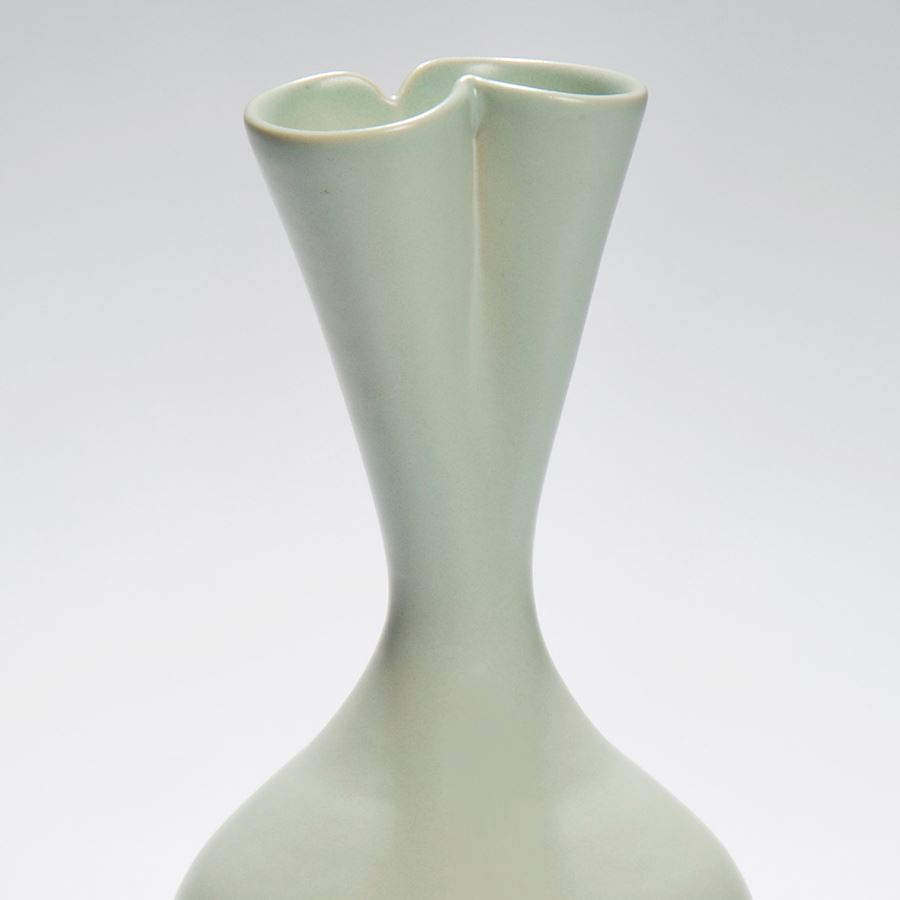 tall green ceramic sculpture of seed pod with twin necked top