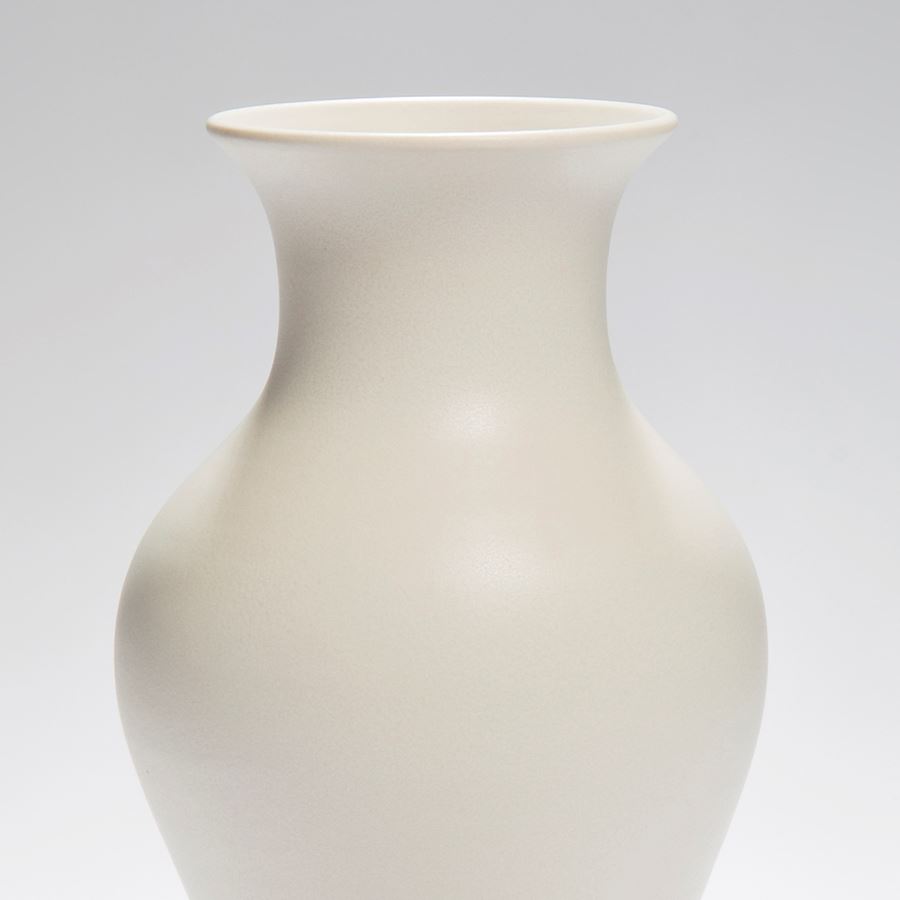 white vase ornament sculpture with wider upper mid section