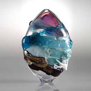 oval shaped clear glass sculpture with turquoise pink and brown splashes of colour
