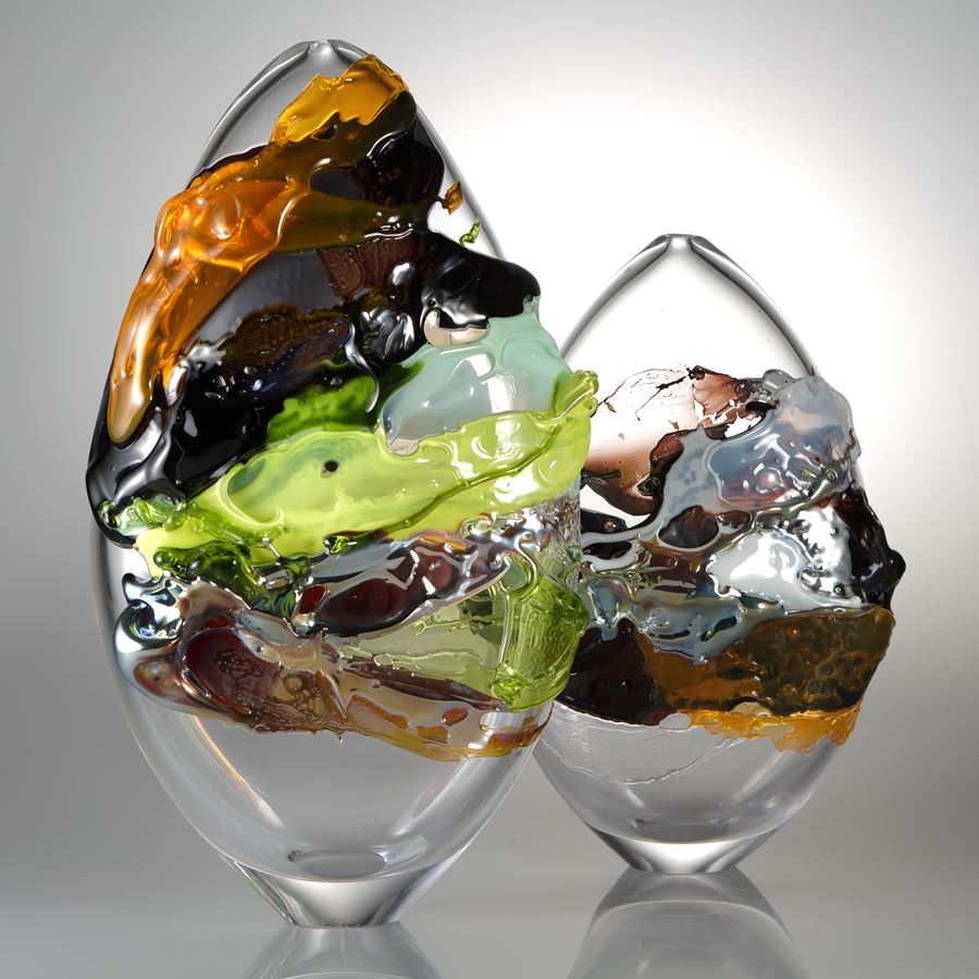 modern oval shaped art glass sculpture with graffiti like external decoration