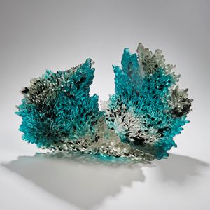 art-glass sculpture of curled leaf in turquoise black and crystal