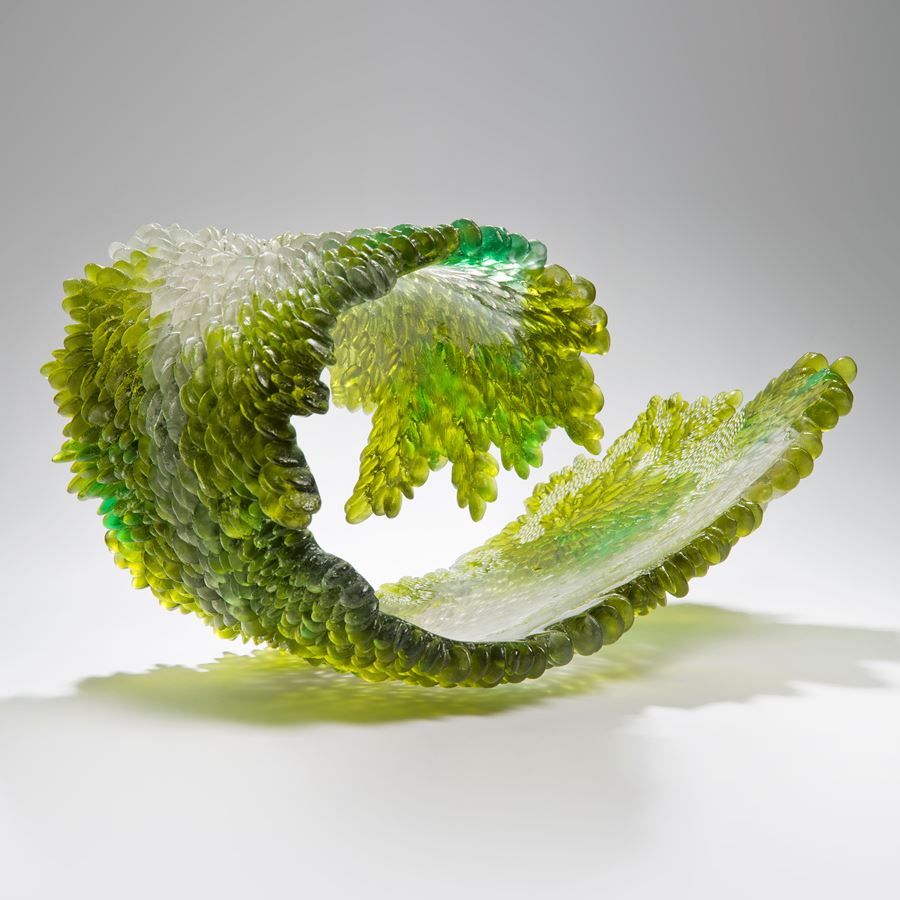 modern art glass sculpture of curled leaf in green