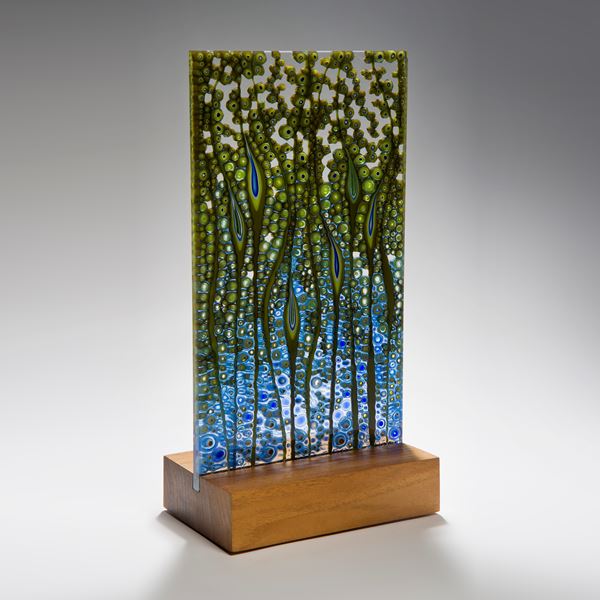 fused glass panel artwork in green and blue on wood base