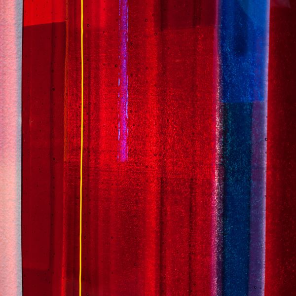 series of five fused glass wall mounted panels in dark blue red and orange shades