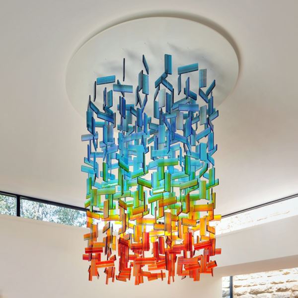 hanging glass installation for interiors made from a large number of rectangular shards in blue green orange and red