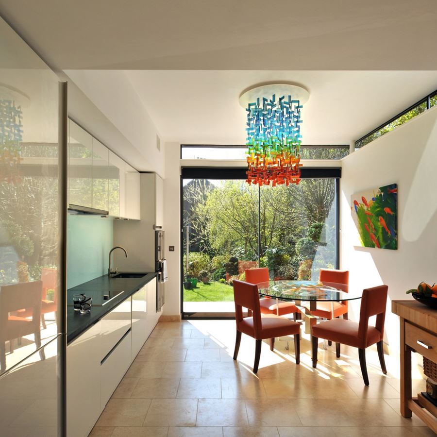 hanging glass installation for interiors made from a large number of rectangular shards in blue green orange and red