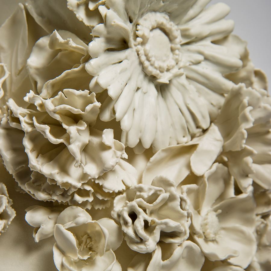 sculpted white medium sized porcelain vase with flower decoration