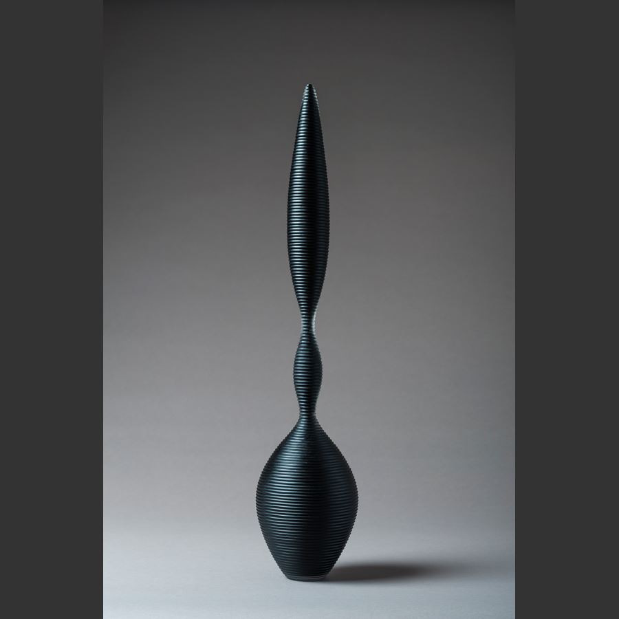 a trio of abstract black sculpted glass ornaments in different sizes