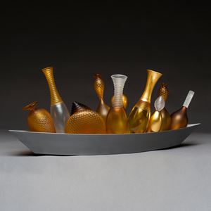 artwork of miniature amber glass vases in long silver tray