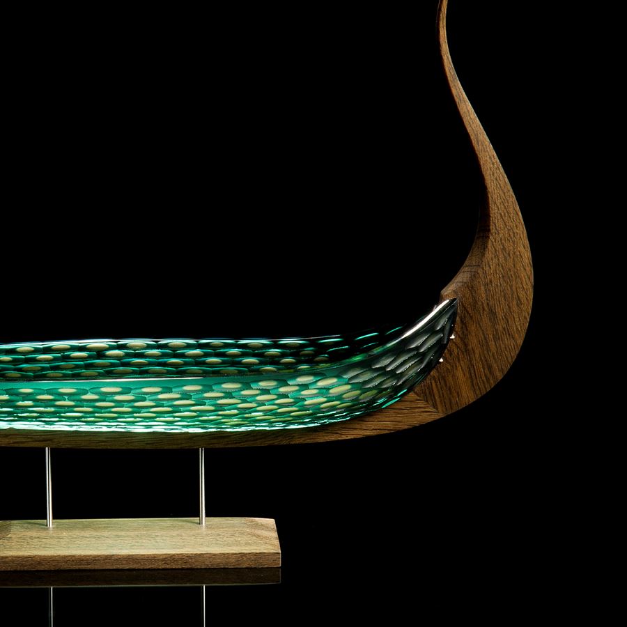 wood and glass sculpture of viking ship in green and brown