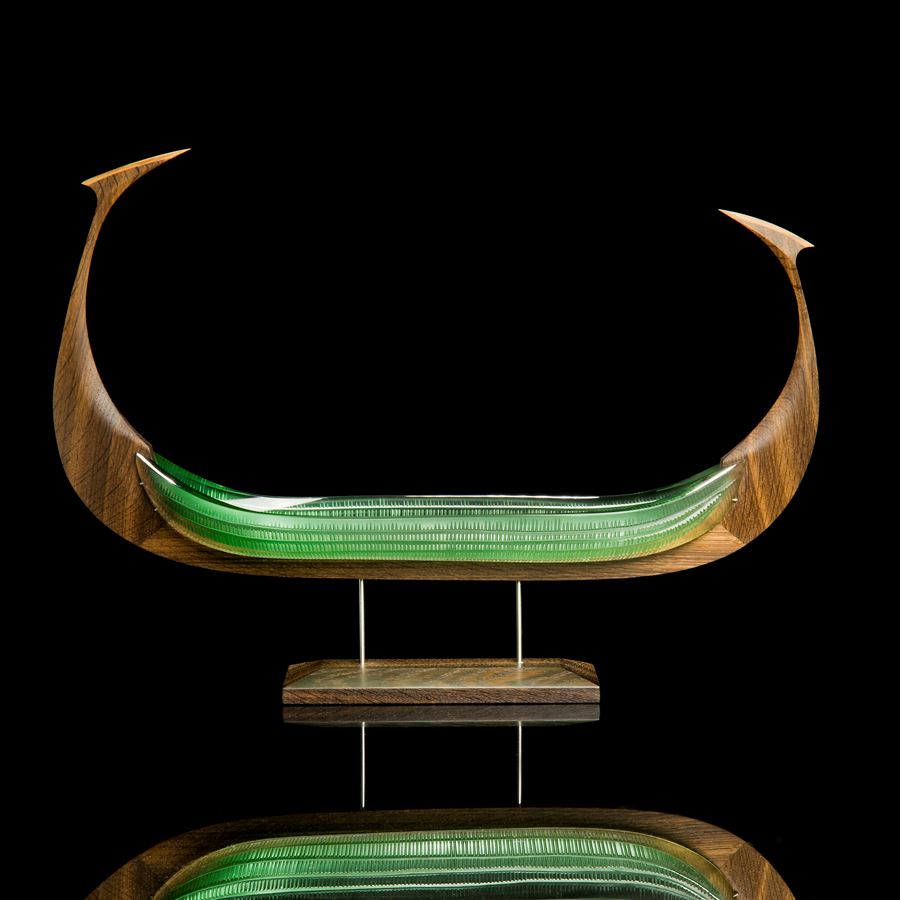 wood and glass sculpture of viking ship in light green and brown on wooden base