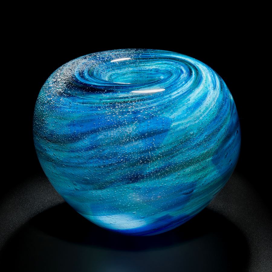 blue and black sculpted glass vessel with ringed swirl pattern