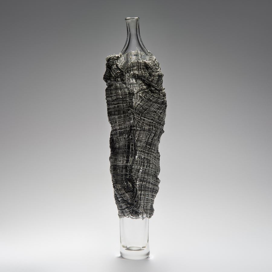 tall glass vase sculpted art work wrapped in dark grey glass cane cloak