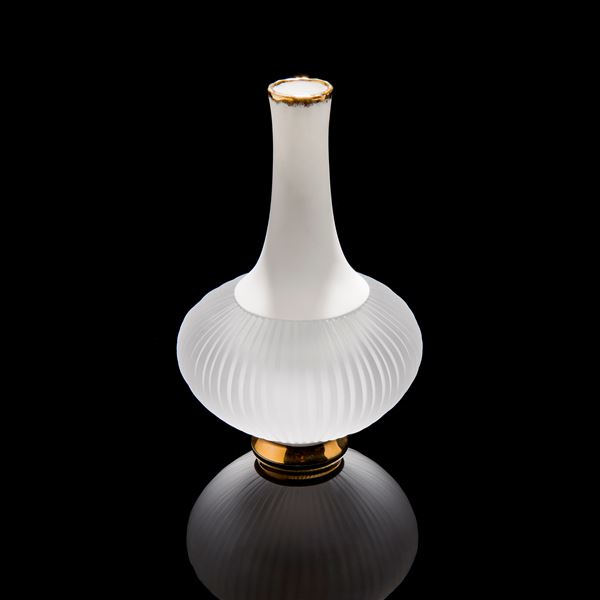 sculpted vessel with wide white glass base and long white porcelain neck on gold base