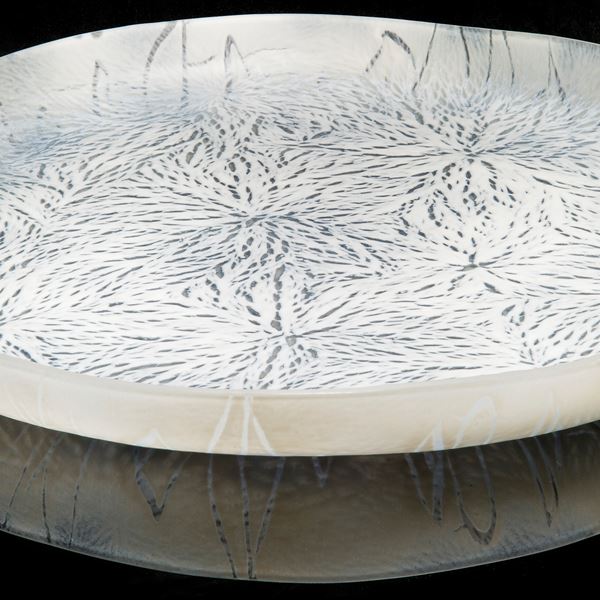 modern art glass sculpture of a large plate in white and black