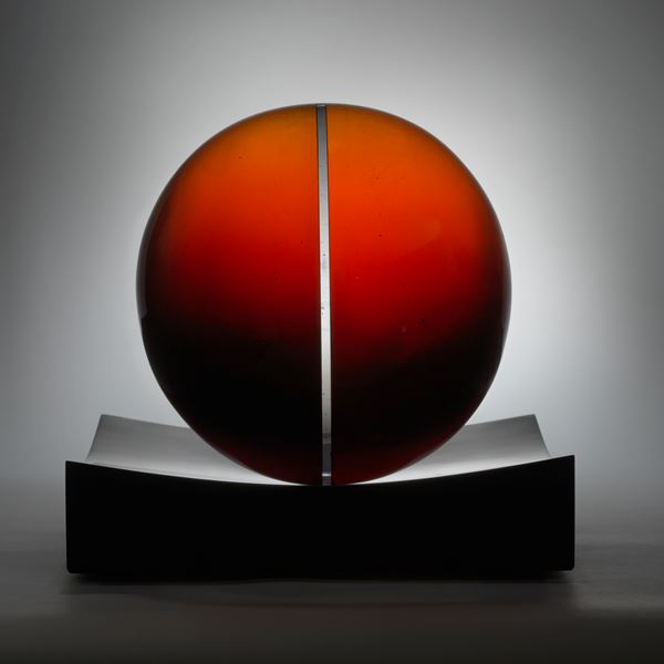 red minimalist art glass spherical sculpture with central line motif