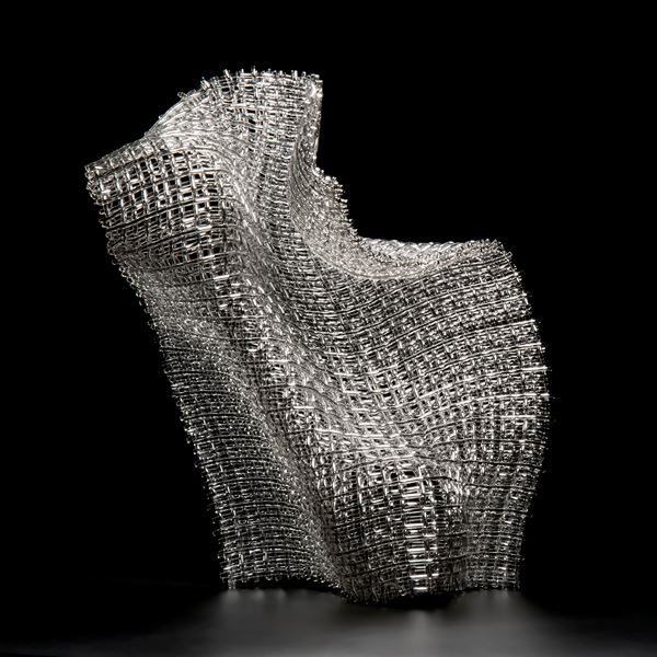 woven art glass sculpture in silver resembling wire mesh structure