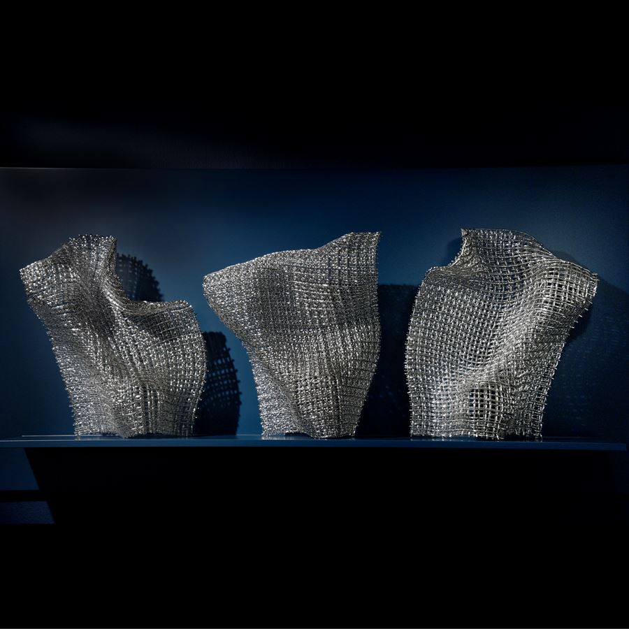 woven art glass sculpture in silver resembling wire mesh structure