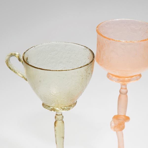 art-glass sculpture of tall glasses in green pink and orange