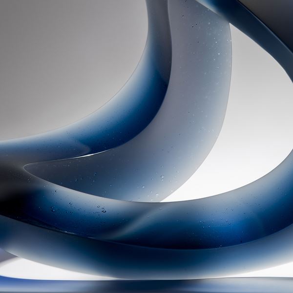 contemporary abstract art-glass sculpture of wave form in blue