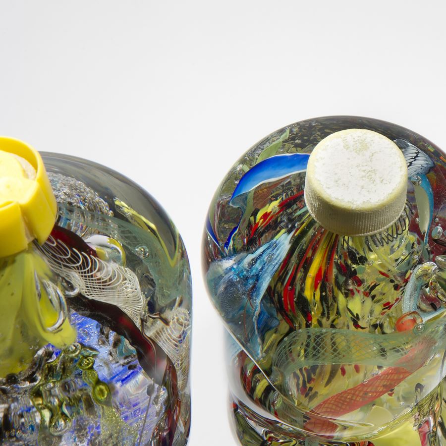 art-glass sculpture of crumpled wasted plastic bottles 