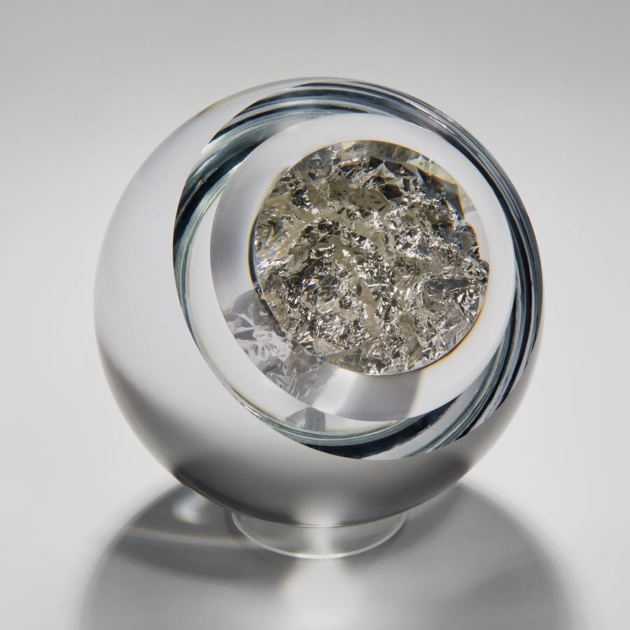 modern art glass orb sculpture with clear glass exterior and genuine silver interior