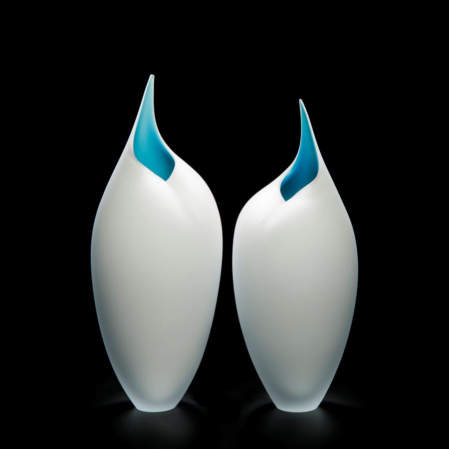 two art glass sculptures of bird like forms in white and turquoise