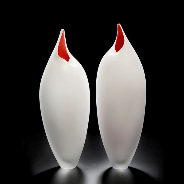 two white glass vases with red tips in the shape of birds