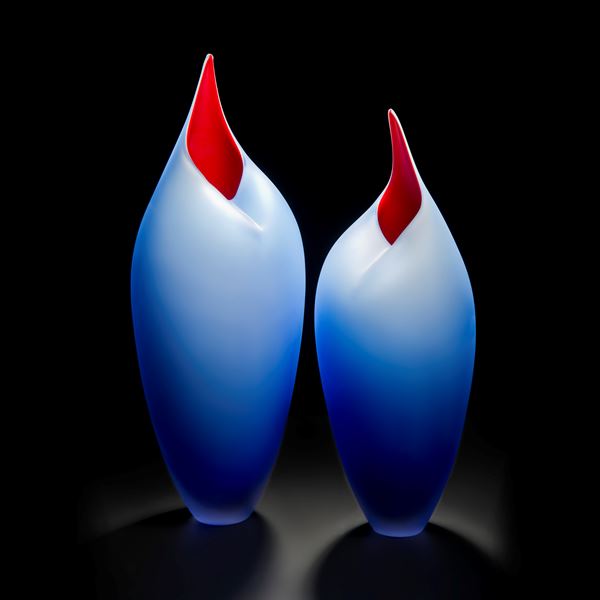 minimalist blown glass sculpture of birds in blue and red