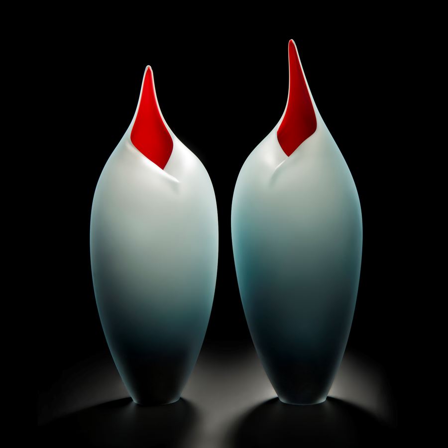 minimal blown glass sculpture of birds in red and steel