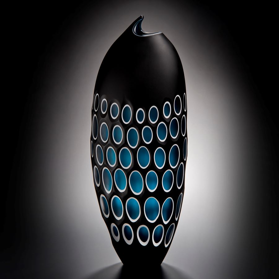 modern art glass sculpture of a fish in black with blue scales