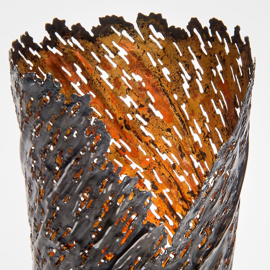contemporary art sculpture of re-formed steel can with orange gold inlay and open edge