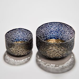 two decorative reformed steel can bowls in blue and grey with gold patterned interior and exterior 