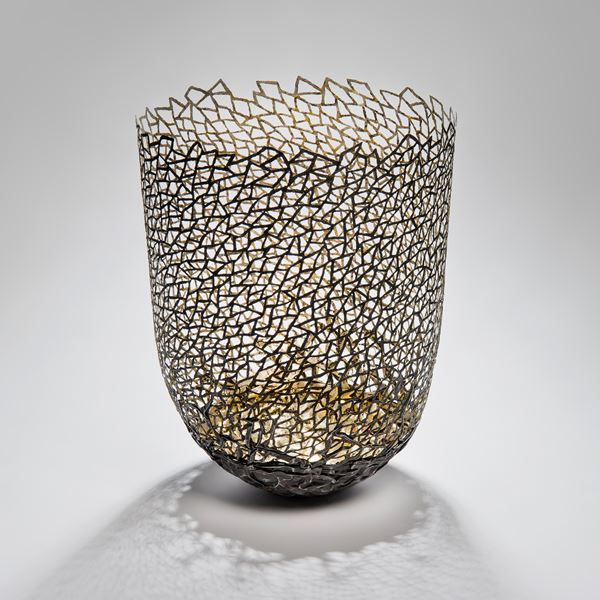 decorative vessel made from metal and wood with mesh exterior