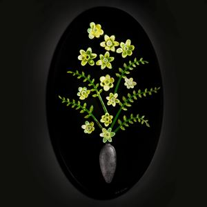 art glass sculpture of flowers in green and yellow on black background