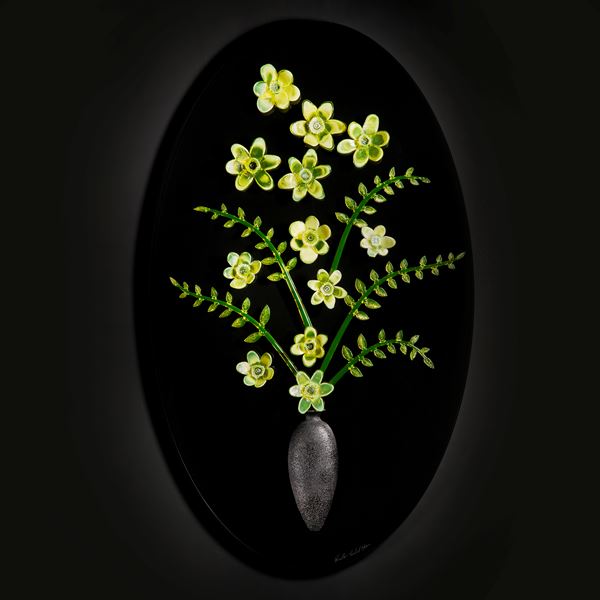 art glass sculpture of flowers in green and yellow on black background