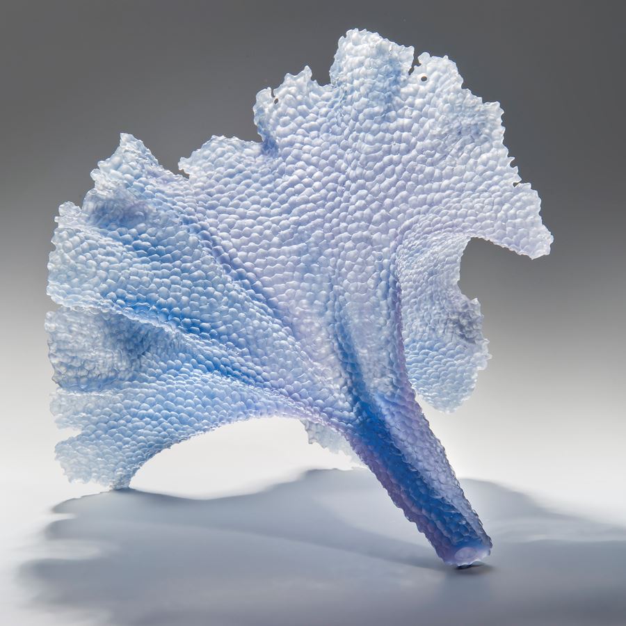 modern art glass sculpture of leaf in light blue